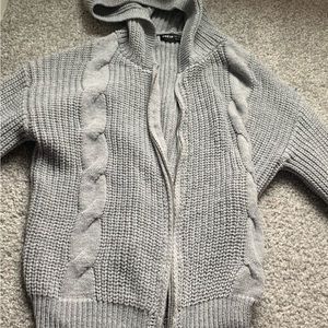 This is a grey zipup sweater hood and it’s from SHEIN